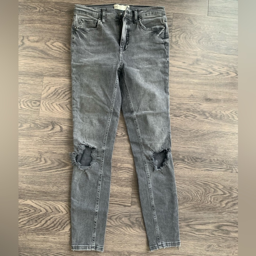 Women’s Free People black wash distressed jeans with rips in knees. Size 27.